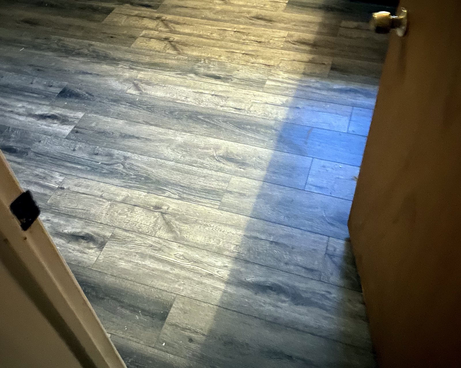 New plank floor in a bathroom remodel by JT's Home Repair in Central Arkansas