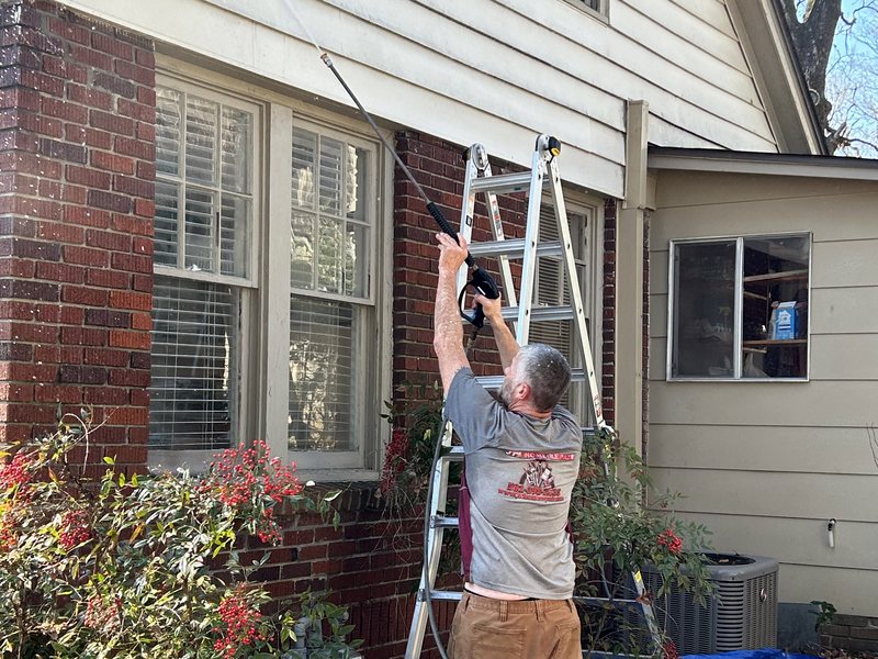 Exterior window maintenance on a brick home in Central Arkansas