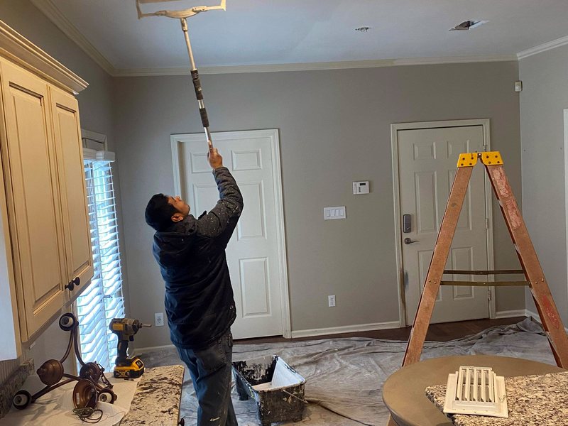 Painting a ceiling with a roller in a Central Arkansas home
